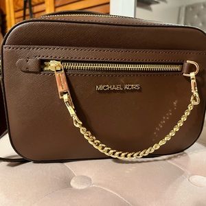 Chocolate brown Michael Kors crossbody bag with gold detail.